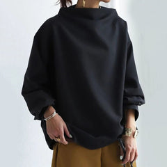 Christine Brewer Ivy high neck knit top for women, featuring a close-up of the ribbed, high neckline and soft knit fabric.