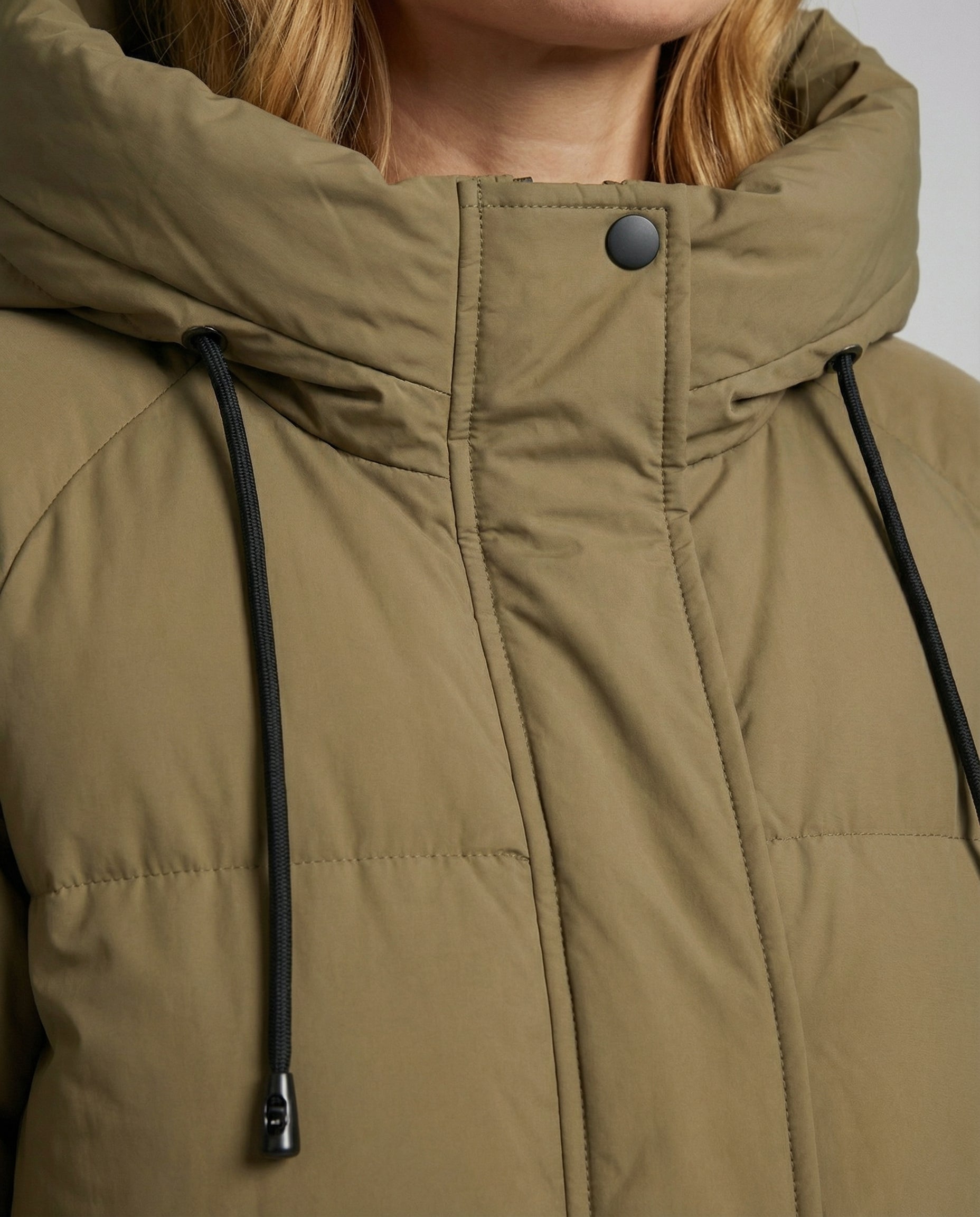 Close-up of Christine Brewer Julia long women's puffer jacket showing quilted fabric and detailed stitching