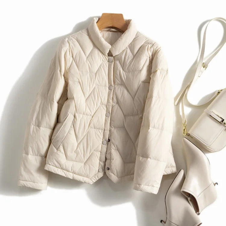 Women’s Aurora quilted puffer jacket by Christine Brewer, lightweight short design with horizontal quilting and cozy collar.