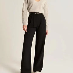 White wide-leg high-waist trousers for women by Christine Brewer, shown on a model, emphasizing relaxed fit and elegant style.