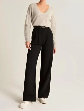 White wide-leg high-waist trousers for women by Christine Brewer, shown on a model, emphasizing relaxed fit and elegant style.