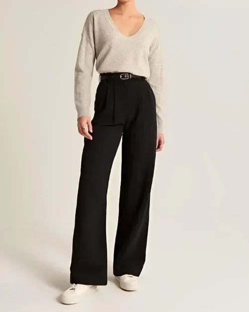 White wide-leg high-waist trousers for women by Christine Brewer, shown on a model, emphasizing relaxed fit and elegant style.