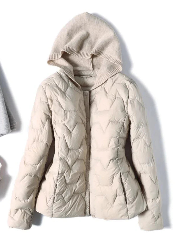 Women’s quilted puffer jacket with hood by Christine Brewer, featuring a stylish quilted design and warm insulation.