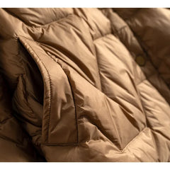 Women’s short quilted puffer jacket by Christine Brewer, featuring a stylish quilted design and cozy insulation.