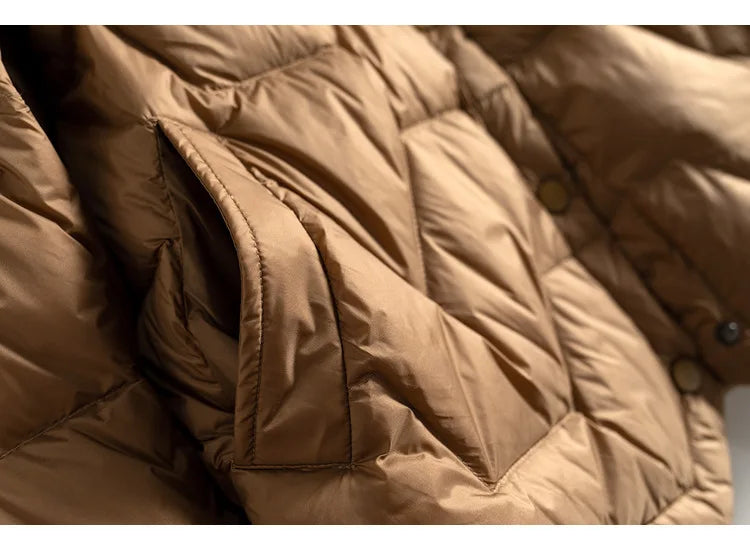 Women’s short quilted puffer jacket by Christine Brewer, featuring a stylish quilted design and cozy insulation.