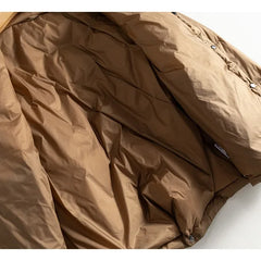 Women’s short quilted puffer jacket by Christine Brewer, featuring a stylish quilted design and lightweight warmth.