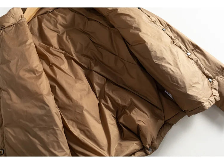 Women’s short quilted puffer jacket by Christine Brewer, featuring a stylish quilted design and lightweight warmth.