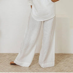 Light beige linen wide-leg trousers for women by Christine Brewer, featuring a loose pull-on design and relaxed fit.