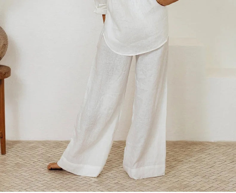 Light beige linen wide-leg trousers for women by Christine Brewer, featuring a loose pull-on design and relaxed fit.