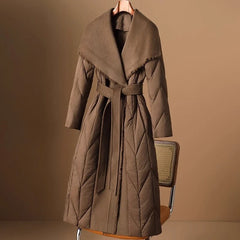 Lily long belted puffer jacket for women by Christine Brewer, shown in a stylish, quilted design with belt and cozy fit.