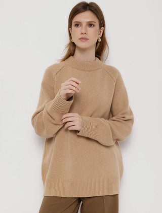 Cream-colored oversized wool sweater for women by Christine Brewer, featuring a cozy, relaxed fit with a textured knit pattern.