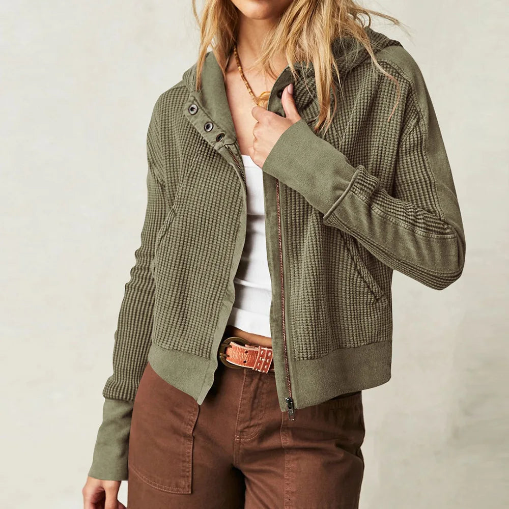 Mia cropped hooded hoodie for women by Christine Brewer, featuring a relaxed fit and drawstring hood, shown in a stylish casual setting.