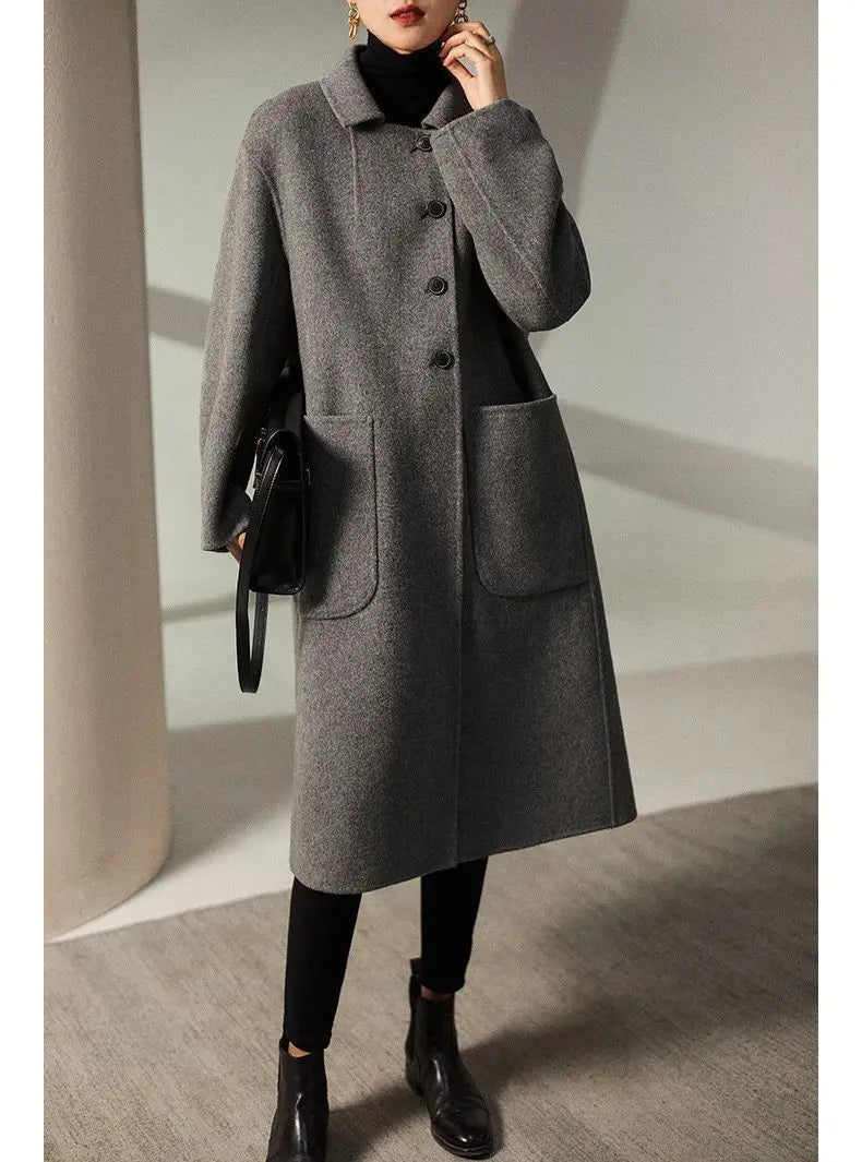 Green long wool coat for women by Christine Brewer, featuring a stylish and cozy design perfect for cold weather.