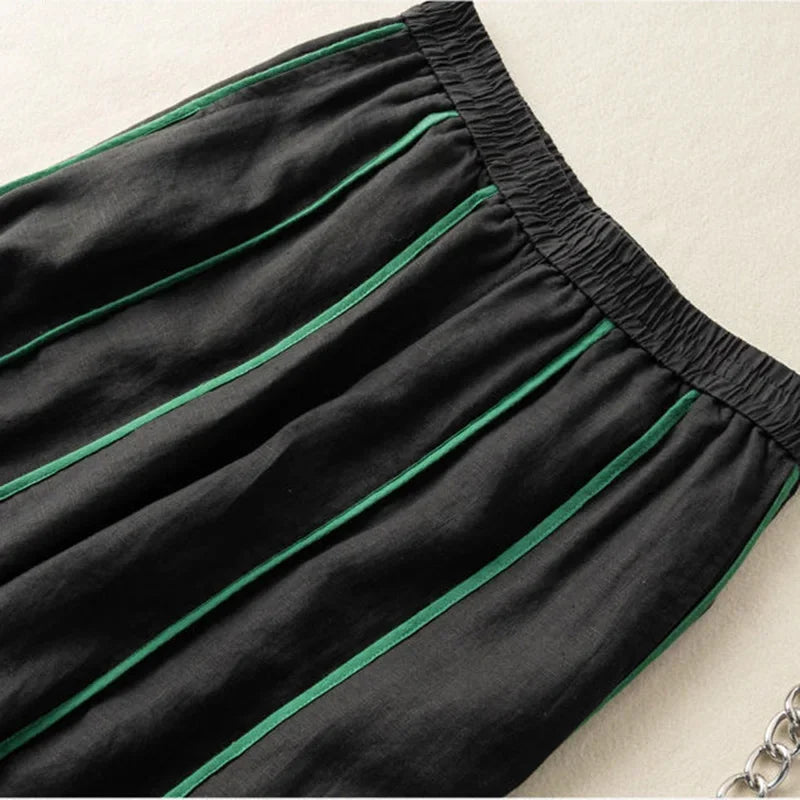 Women’s linen wide-leg elastic-waist trousers by Christine Brewer, loose pull-on pants with a relaxed fit, shown in a neutral color.