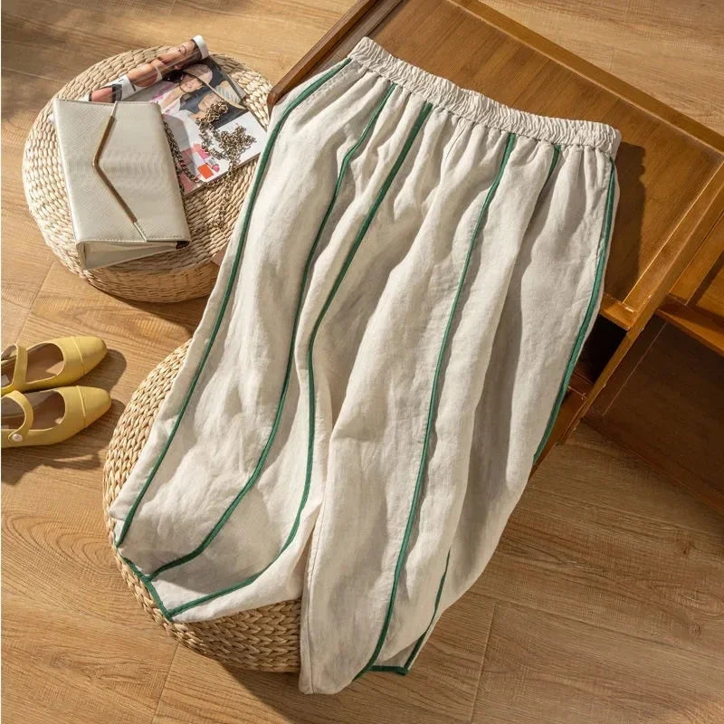 Light beige linen wide-leg elastic-waist trousers for women, loose pull-on style, by Christine Brewer, shown on a model.