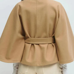 Emma belted cape coat for women by Christine Brewer, shown in a stylish, elegant design with fabric draped over the shoulders.