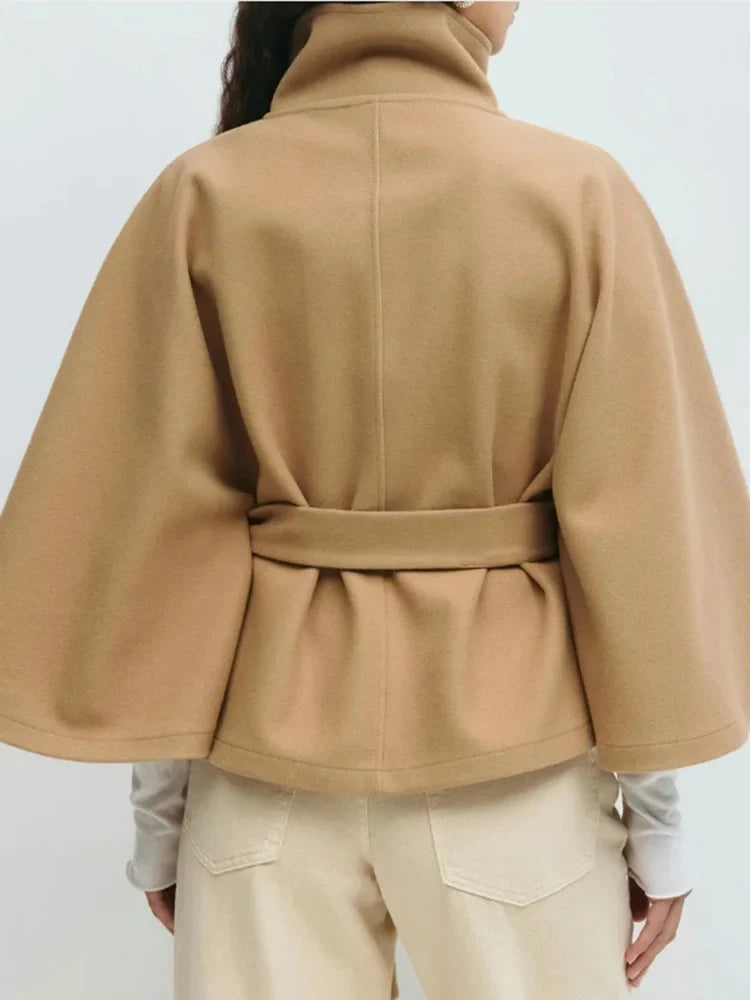 Emma belted cape coat for women by Christine Brewer, shown in a stylish, elegant design with fabric draped over the shoulders.