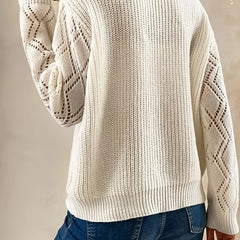 Beige V-neck sweater for women by Christine Brewer, featuring a relaxed fit and soft knit fabric, showcased on a model.