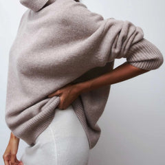 Cream-colored Erica oversized turtleneck sweater for women by Christine Brewer, featuring a cozy fit and knit texture.
