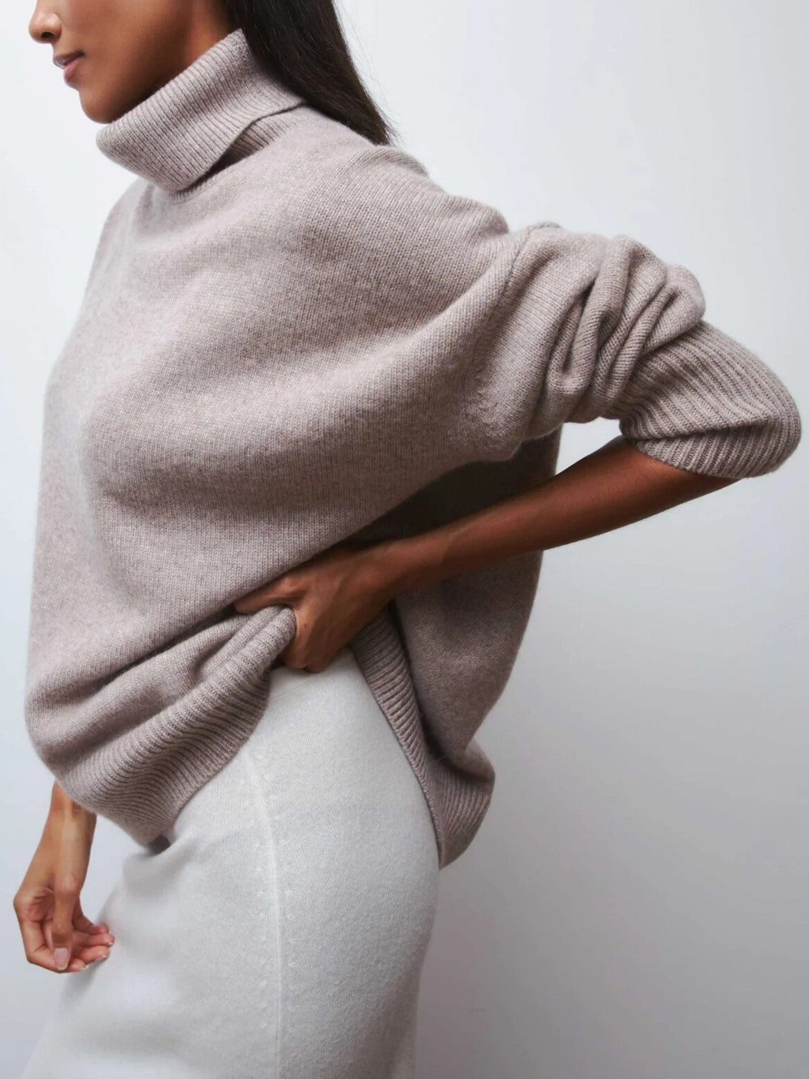 Cream-colored Erica oversized turtleneck sweater for women by Christine Brewer, featuring a cozy fit and knit texture.