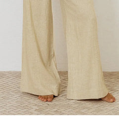 Light beige linen wide-leg trousers for women, loose pull-on style by Christine Brewer, shown on a model.