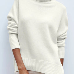Cream-colored Erica oversized turtleneck sweater for women by Christine Brewer, featuring a cozy, relaxed fit and ribbed neckline.