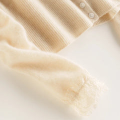 Elsa cashmere cardigan for women by Christine Brewer, soft cream-colored knit sweater with a cozy, elegant fit and button closure.