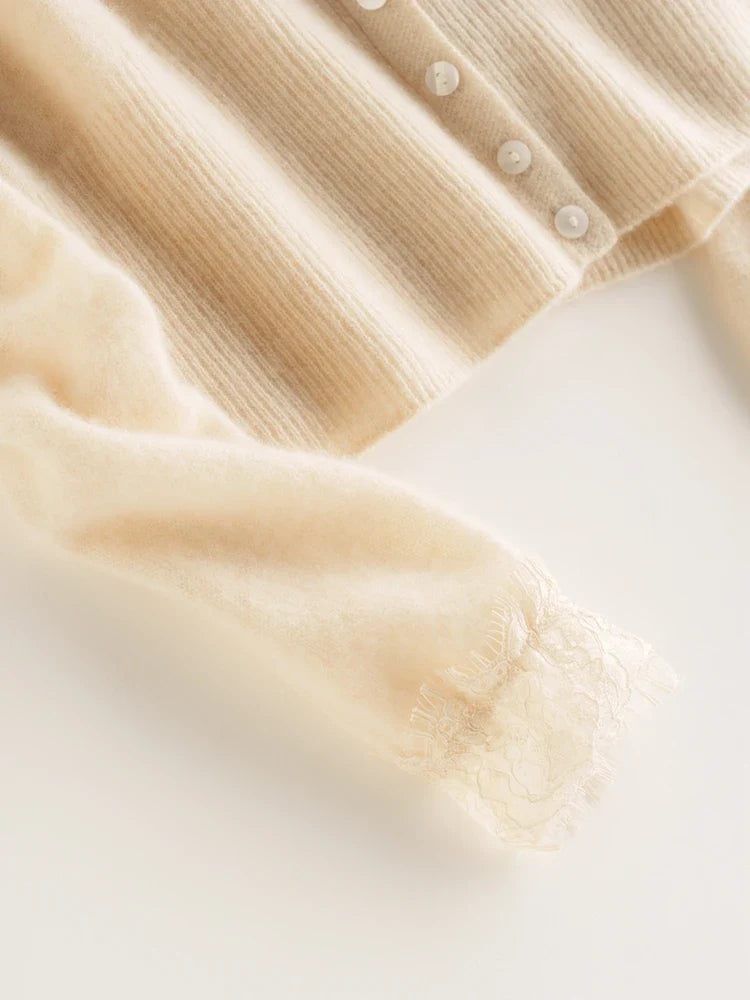 Elsa cashmere cardigan for women by Christine Brewer, soft cream-colored knit sweater with a cozy, elegant fit and button closure.