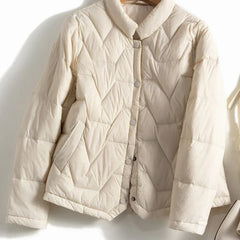 Women's Aurora short quilted puffer jacket by Christine Brewer with a stylish, insulated design perfect for chilly weather.