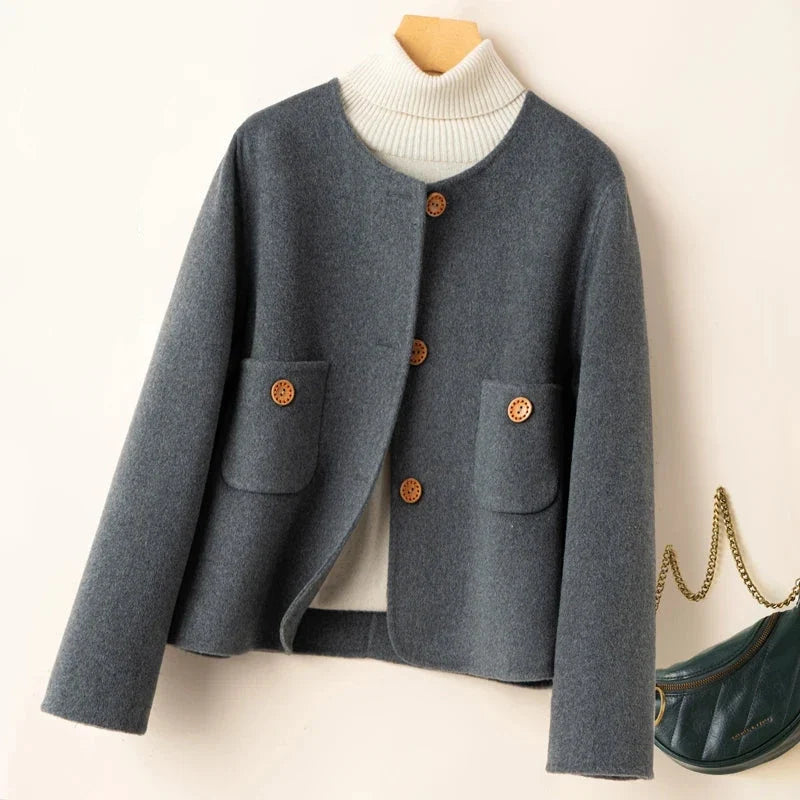 Elegant wool coat for women by Christine Brewer, featuring a tailored fit and classic design in a neutral color.