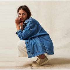 Charlotte oversized denim shirt jacket for women by Christine Brewer, shown in classic blue denim with button-front and relaxed fit.