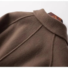 Brown double-breasted wool coat for women by Christine Brewer, styled with a classic tailored fit and button details.