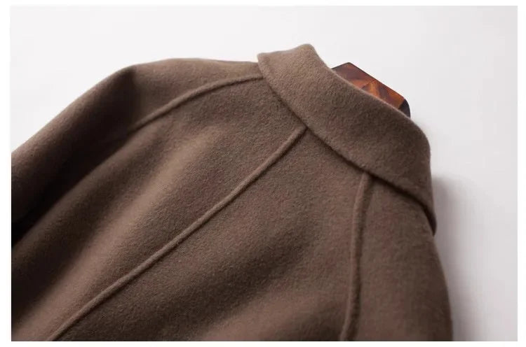 Brown double-breasted wool coat for women by Christine Brewer, styled with a classic tailored fit and button details.