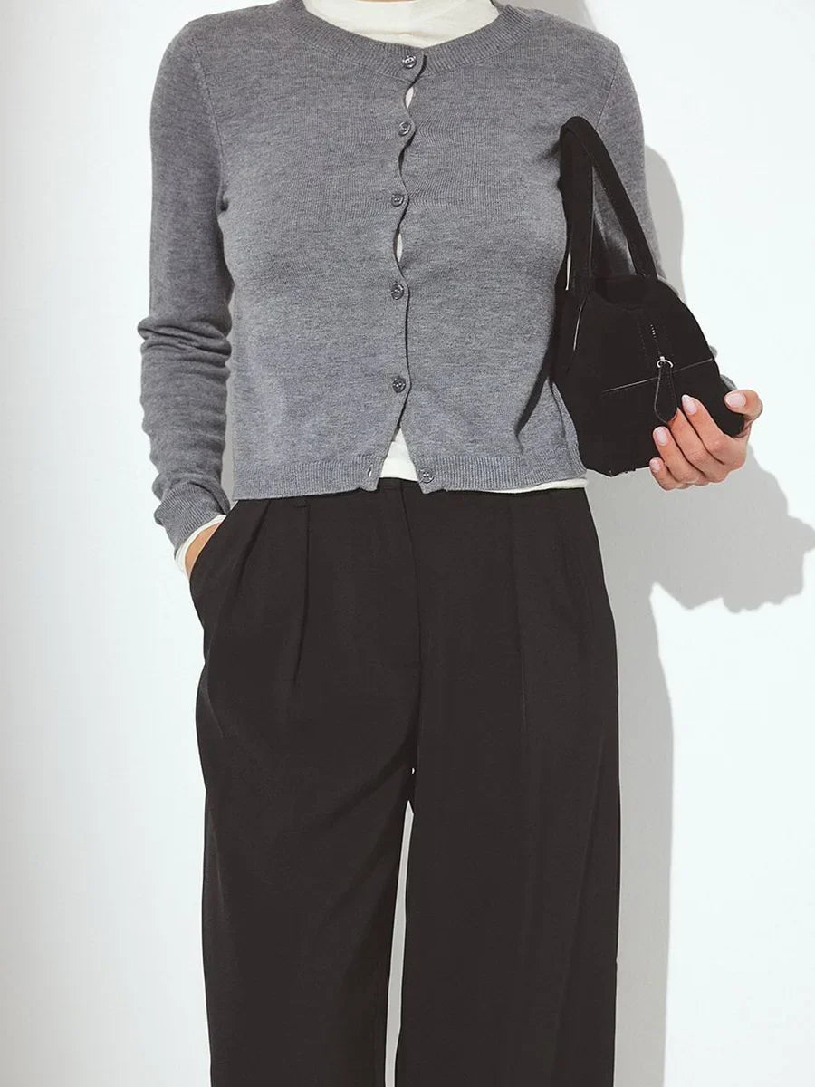 Women’s knit cardigan by Christine Brewer, featuring a cozy Finley design, shown in a soft, neutral color with button details.