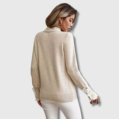Women’s ribbed sweater by Christine Brewer featuring a cozy, fitted design in soft knit fabric, shown in a neutral color.