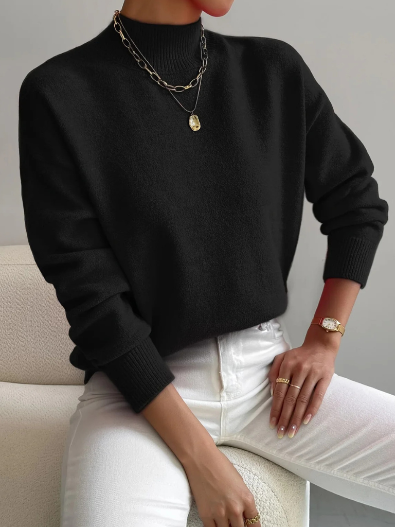Cream-colored high neck sweater for women by Christine Brewer, featuring a cozy fit and ribbed texture.