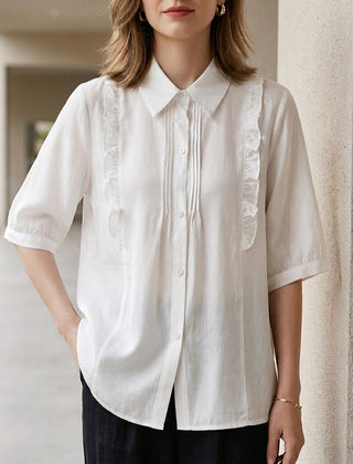 White denim ruffle summer blouse for women by Christine Brewer, featuring a stylish ruffled design and lightweight fabric.