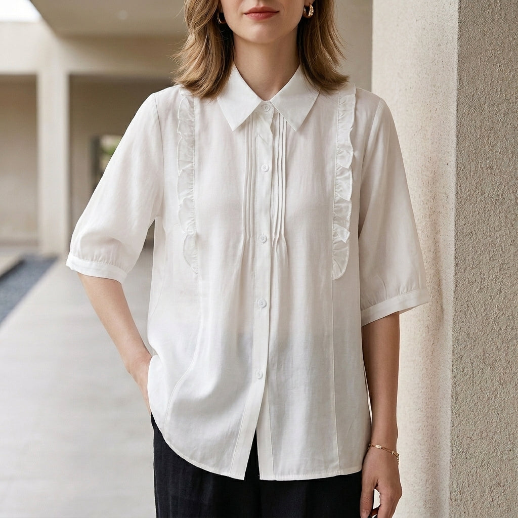 White denim ruffle summer blouse for women by Christine Brewer, featuring a stylish ruffled design and lightweight fabric.