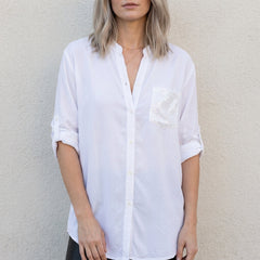 White women's summer blouse with V-neck and denim button front from Christine Brewer, styled as a casual top.