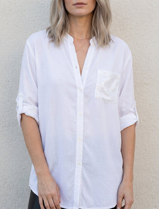 White women's summer blouse with V-neck and denim button front from Christine Brewer, styled as a casual top.