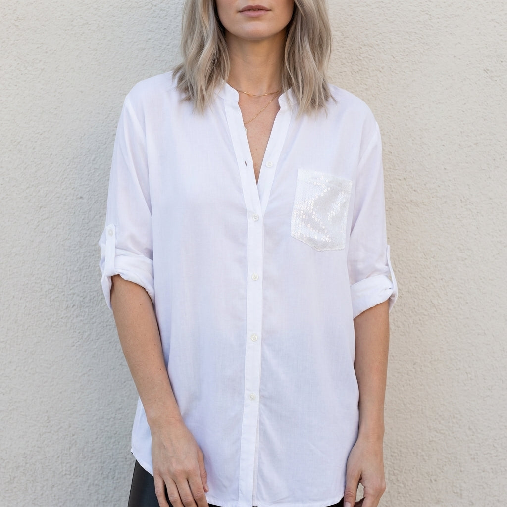 White women's summer blouse with V-neck and denim button front from Christine Brewer, styled as a casual top.
