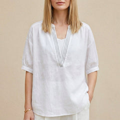 White summer blouse for women by Christine Brewer featuring a V-neck and puff sleeves, perfect for warm-weather outfits.