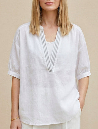 White summer blouse for women by Christine Brewer featuring a V-neck and puff sleeves, perfect for warm-weather outfits.