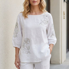 White floral puff sleeve summer blouse for women by Christine Brewer, featuring feminine design and lightweight fabric.