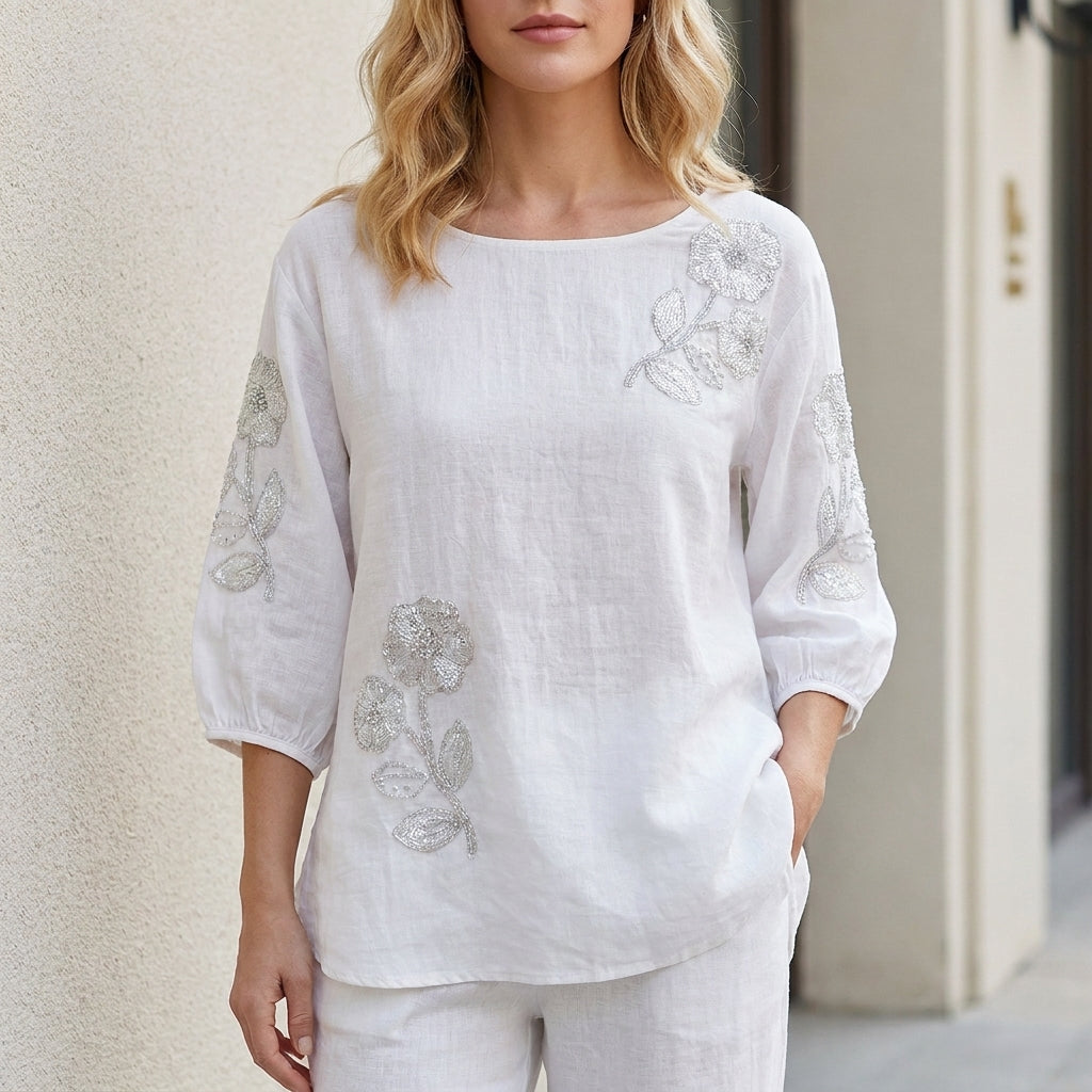 White floral puff sleeve summer blouse for women by Christine Brewer, featuring feminine design and lightweight fabric.