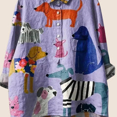 Women wearing a relaxed dog-print graphic button-up shirt by Christine Brewer, showcasing a casual, stylish women's shirt.