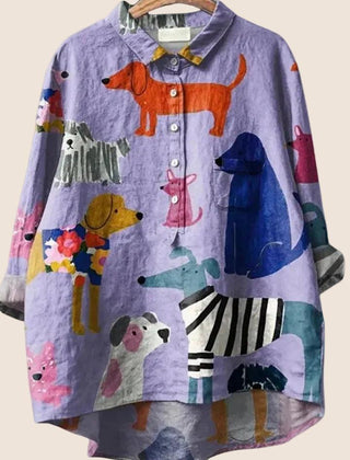 Women wearing a relaxed dog-print graphic button-up shirt by Christine Brewer, showcasing a casual, stylish women's shirt.