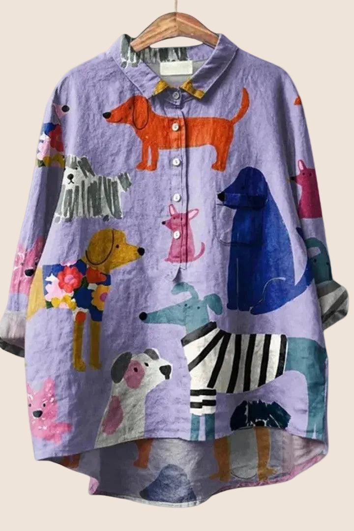 Women wearing a relaxed dog-print graphic button-up shirt by Christine Brewer, showcasing a casual, stylish women's shirt.