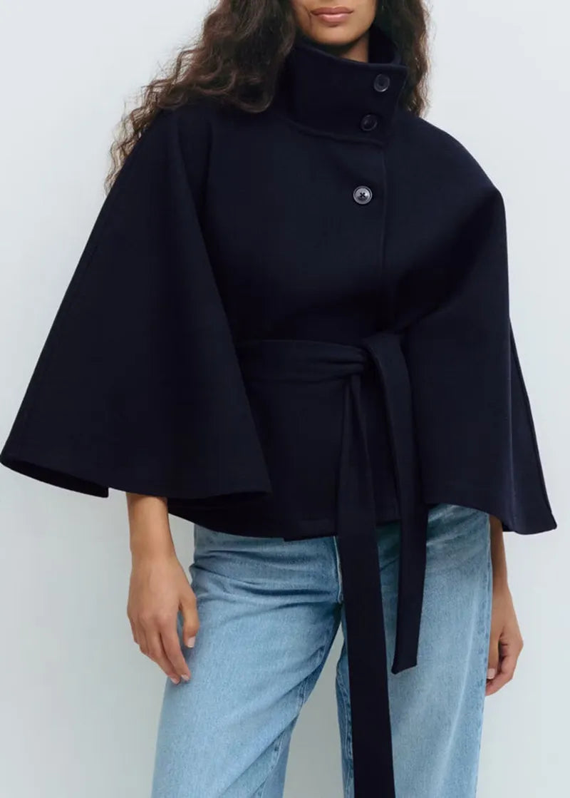 Women's high-neck belted cape coat with short sleeves and funnel neck design by Christine Brewer, perfect for spring.