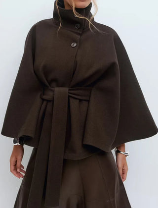 Daisy women's spring belted high-neck cape coat by Christine Brewer, featuring a funnel neckline, belted waist, and cape sleeves.